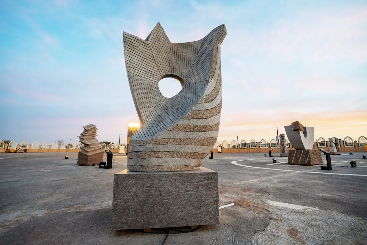 A monumental stone sculpture at Tuwaiq Sculpture in Riyadh at sunset.