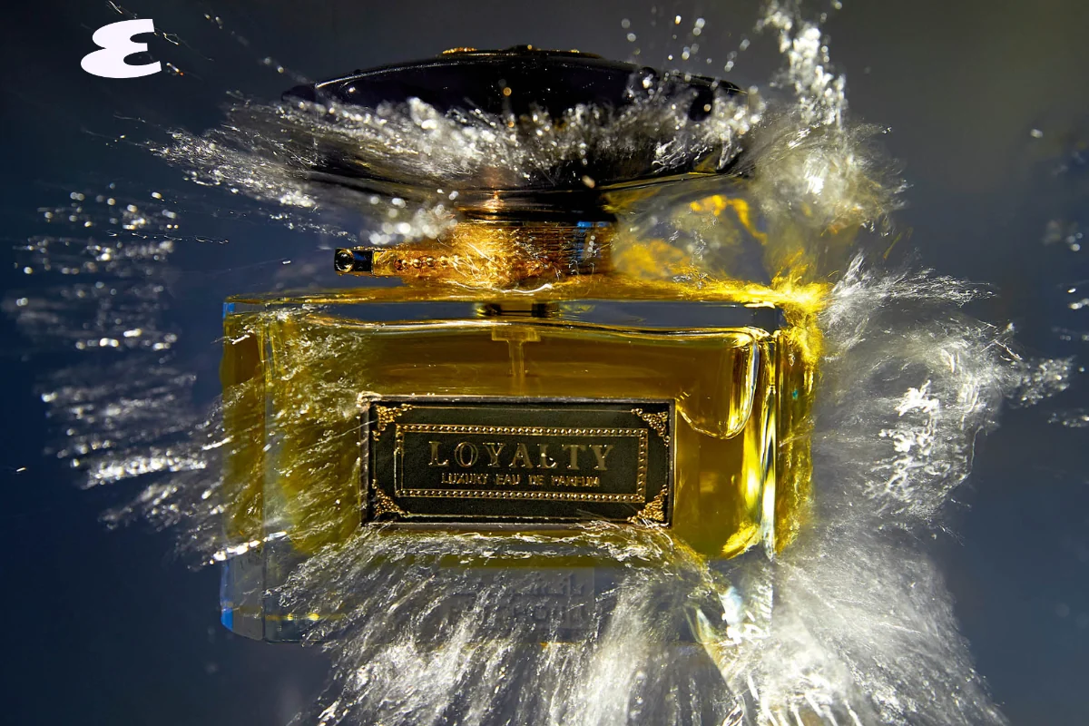A Loyalty perfume bottle surrounded by splashing water.