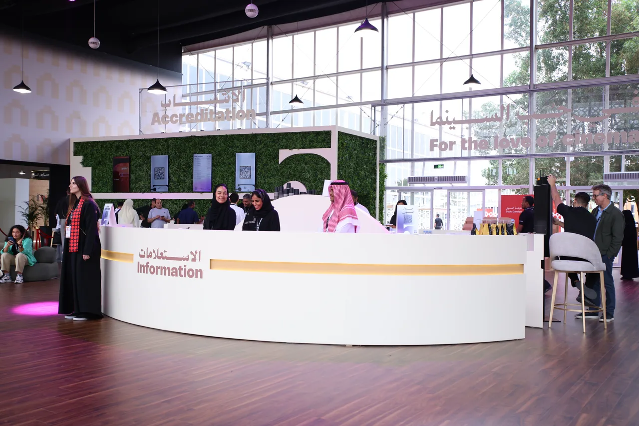 Festival staff and visitors at the information and media accreditation area.