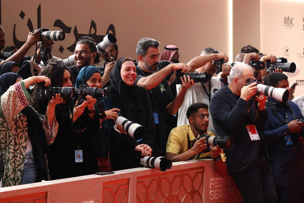 Photographers and camera operators gather at the Red Sea Film Festival press line.