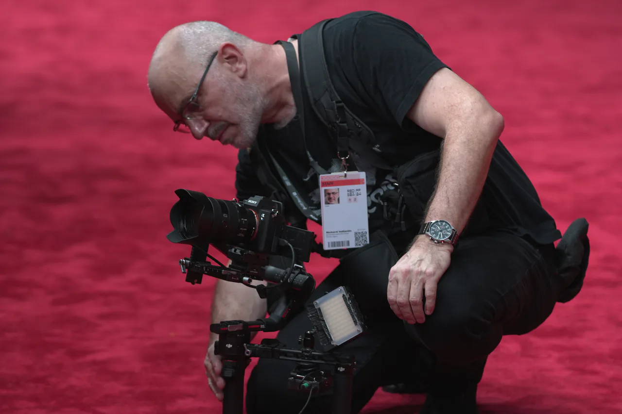A Getty Images camera operator prepares equipment on the Red Sea Film Festival red carpet.