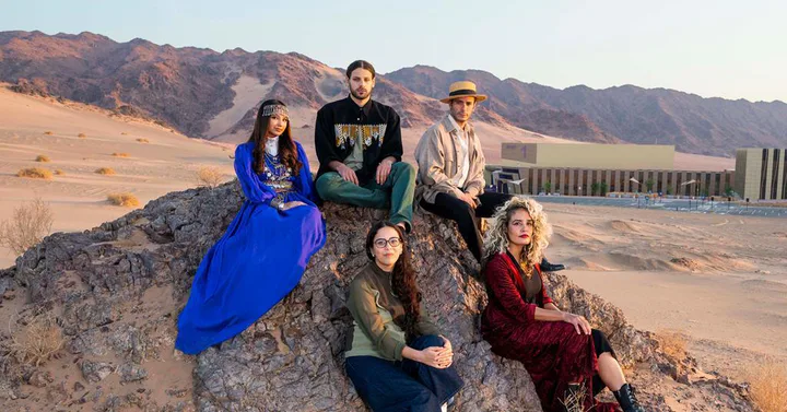 The Arab Stars of Tomorrow cohort photographed together in the AlUla landscape.