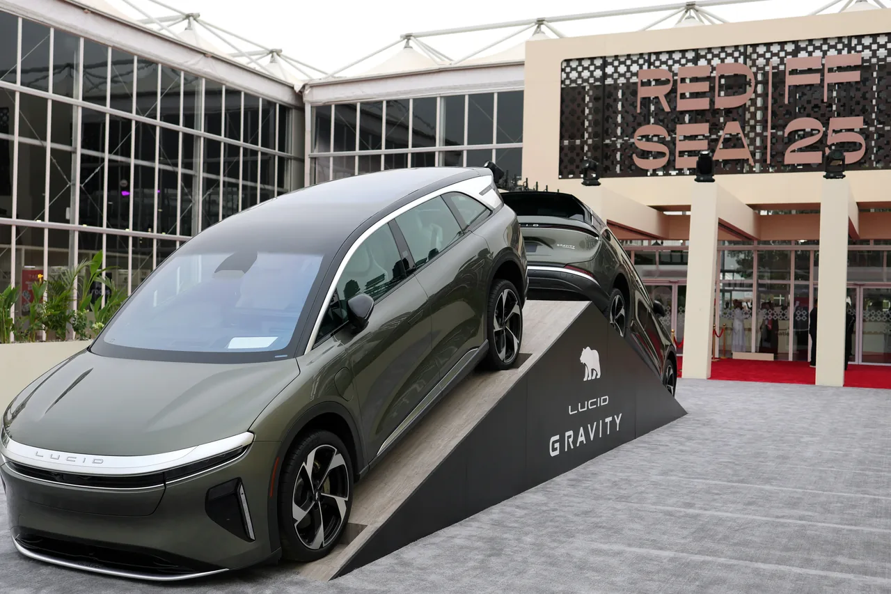 Two Lucid Gravity vehicles displayed on a ramp before the Red Sea International Film Festival 2025 entrance.